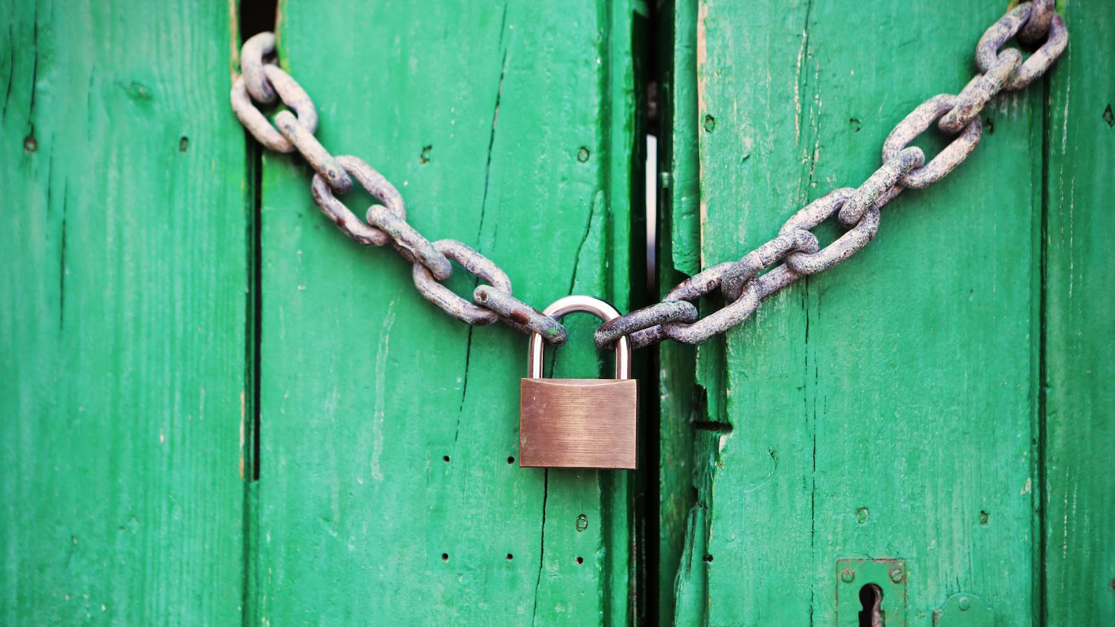 Brass-colored Metal Padlock With Chain