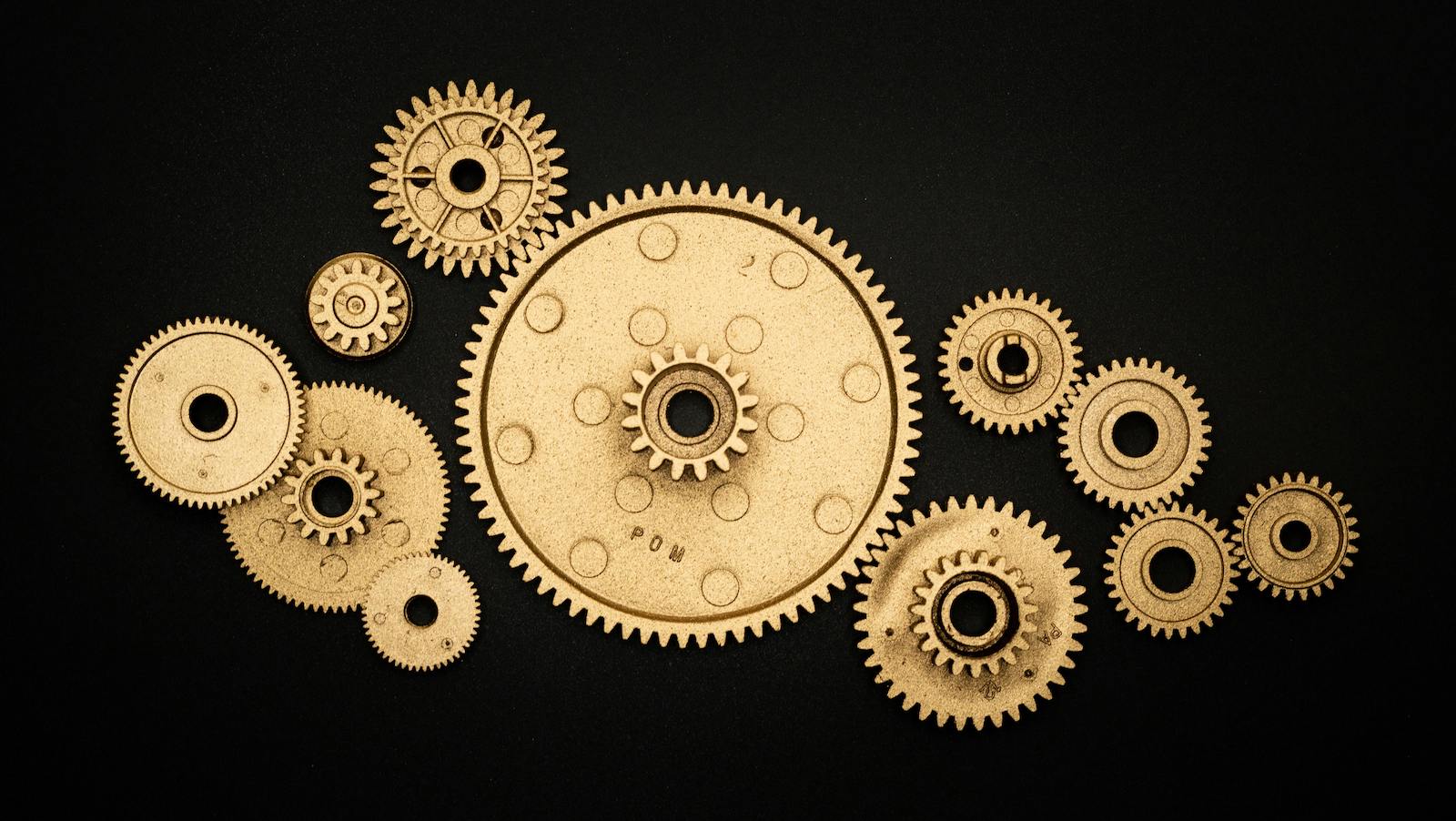 Photo of Golden Cogwheels on Black Background