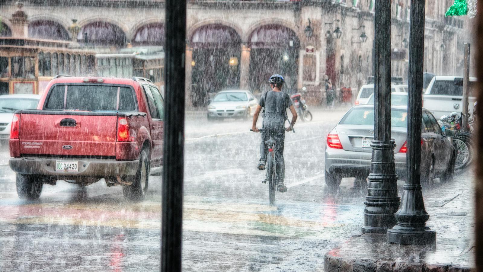 Person Riding a Bicycle during Rainy Day