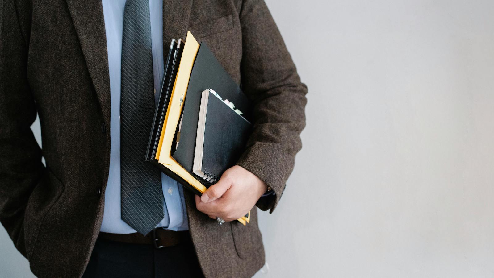 Office worker standing with papers in hand