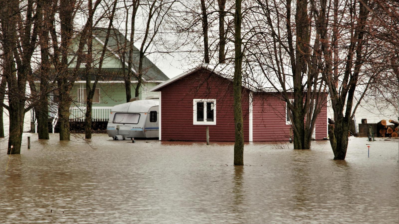 A Red and Green House Surrounded with Water