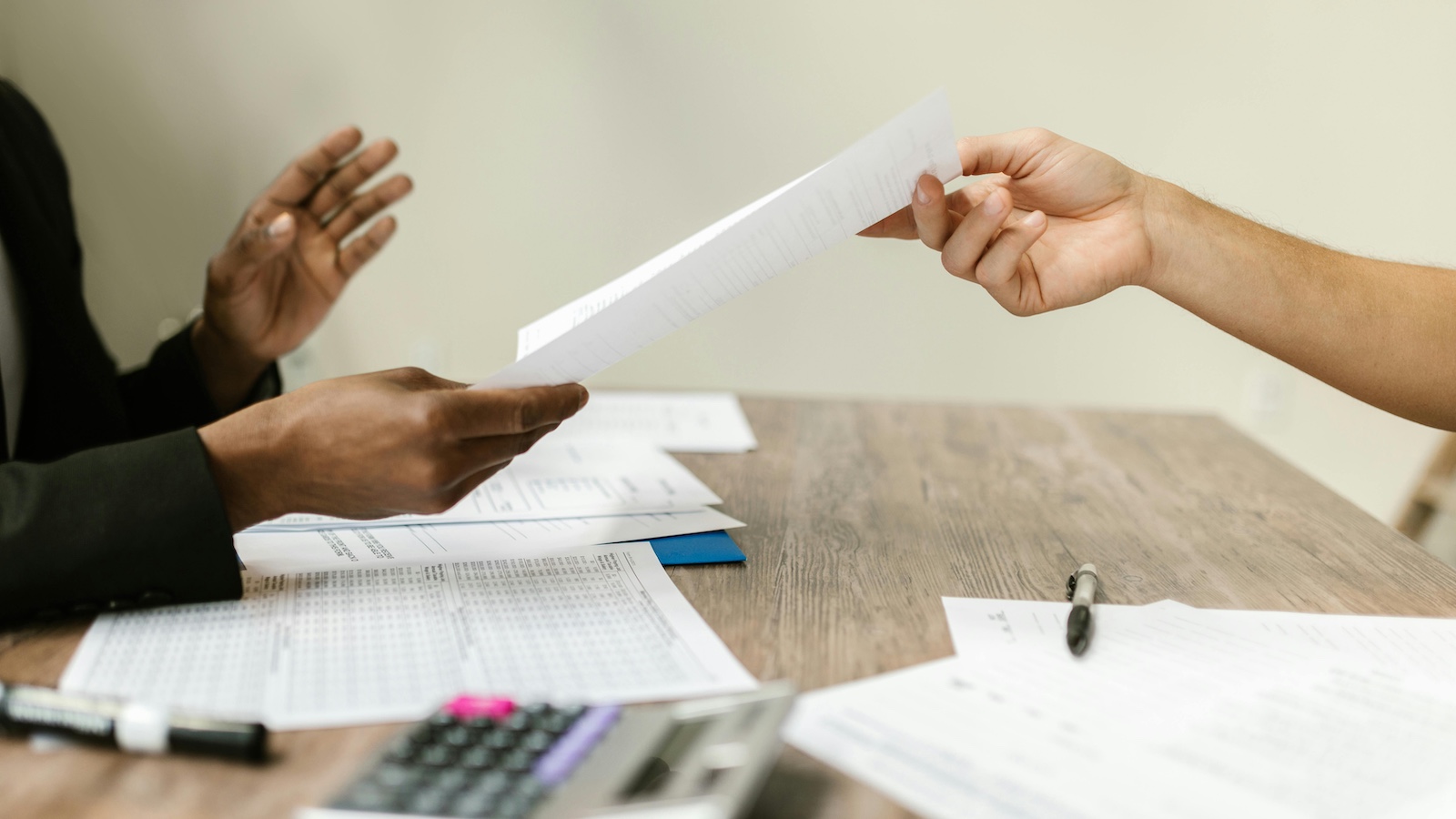 A Person Passing a Document