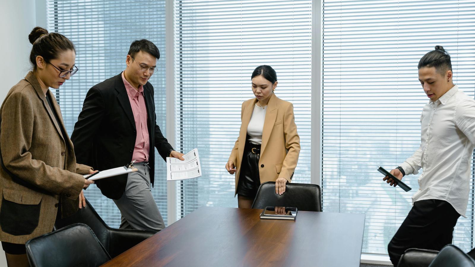 People Sitting Down on Chairs at the Conference Room