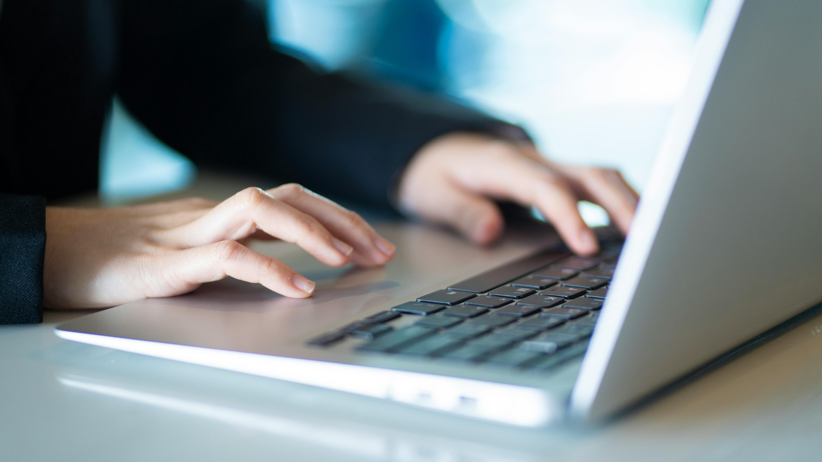 person typing on laptop