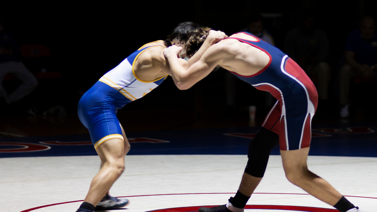 2 Amateur Wrestlers Wrestling in the middle of a wrestling mat