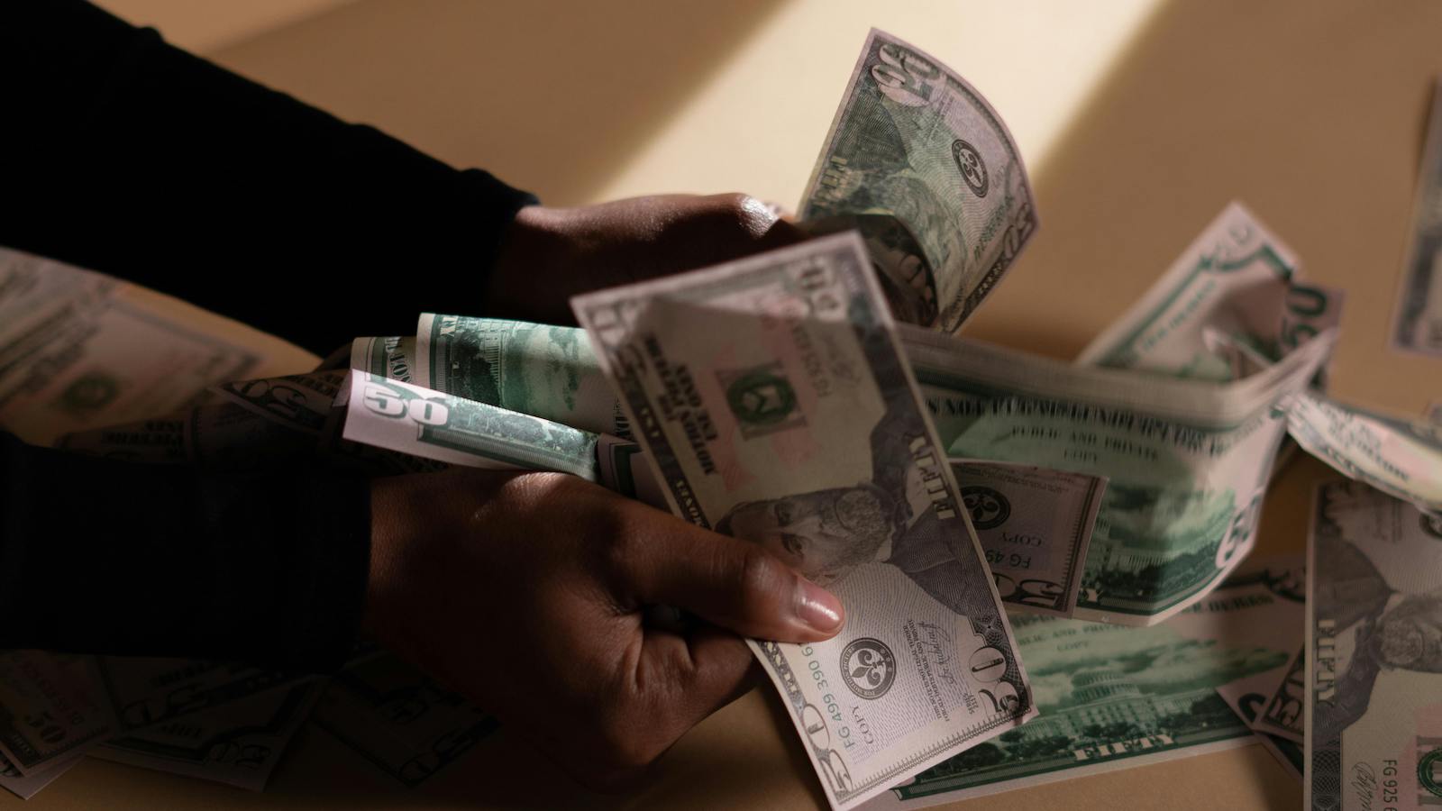 Person Holding Banknotes