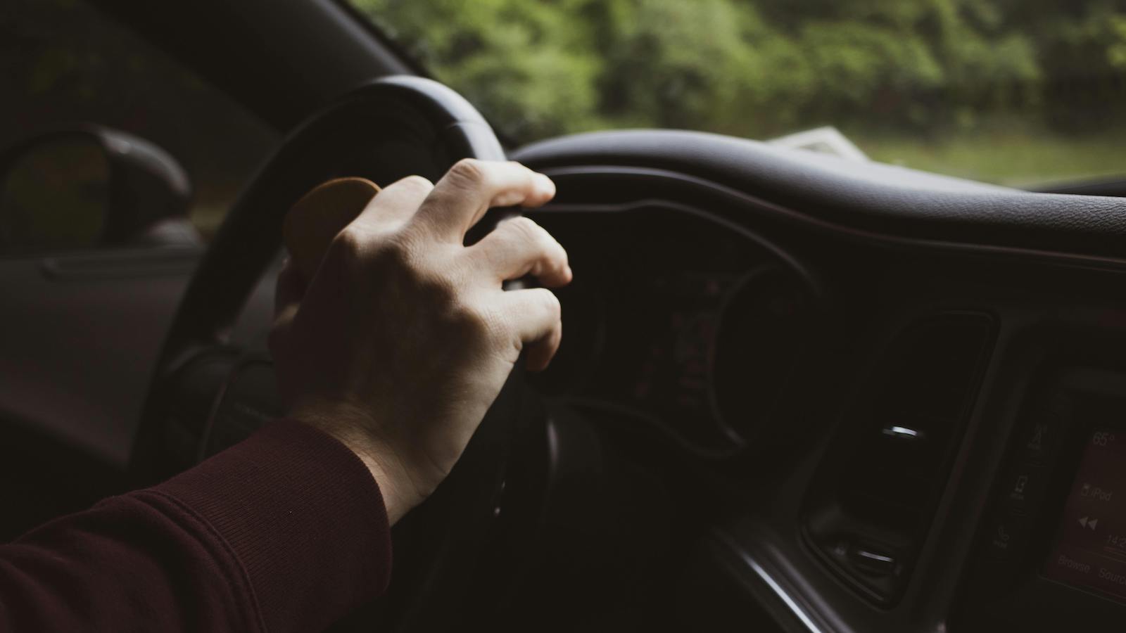 Hand Resting on Steering Wheel