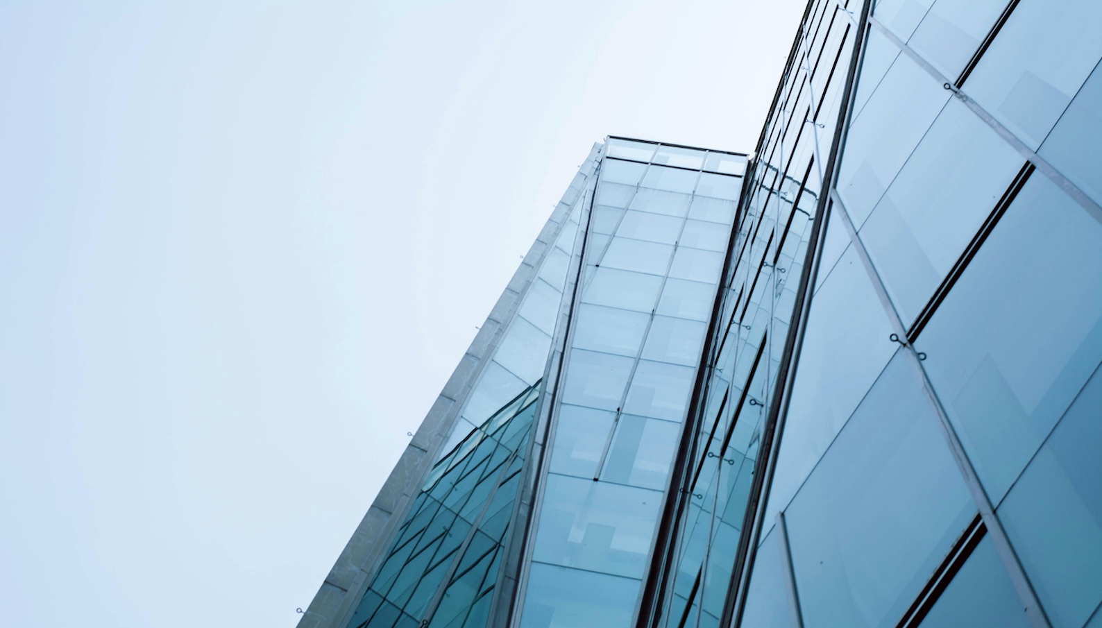 Low-Angle Shot of a Tall Glass Building under the Sky