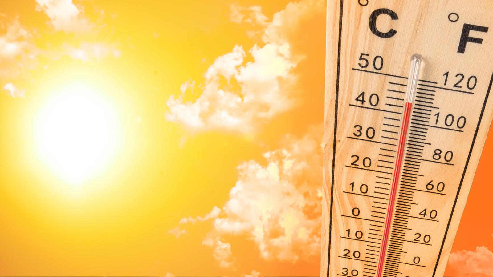 Yellow Sun and Sky with a Thermometer Showing High Temperatures