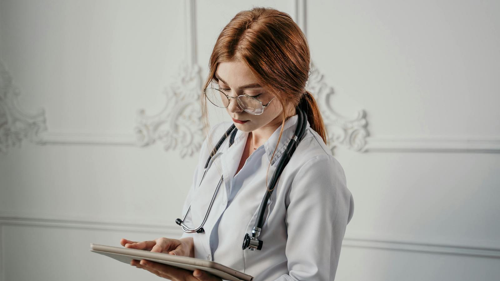 Woman Wearing Medical Scrubs Using a Tablet