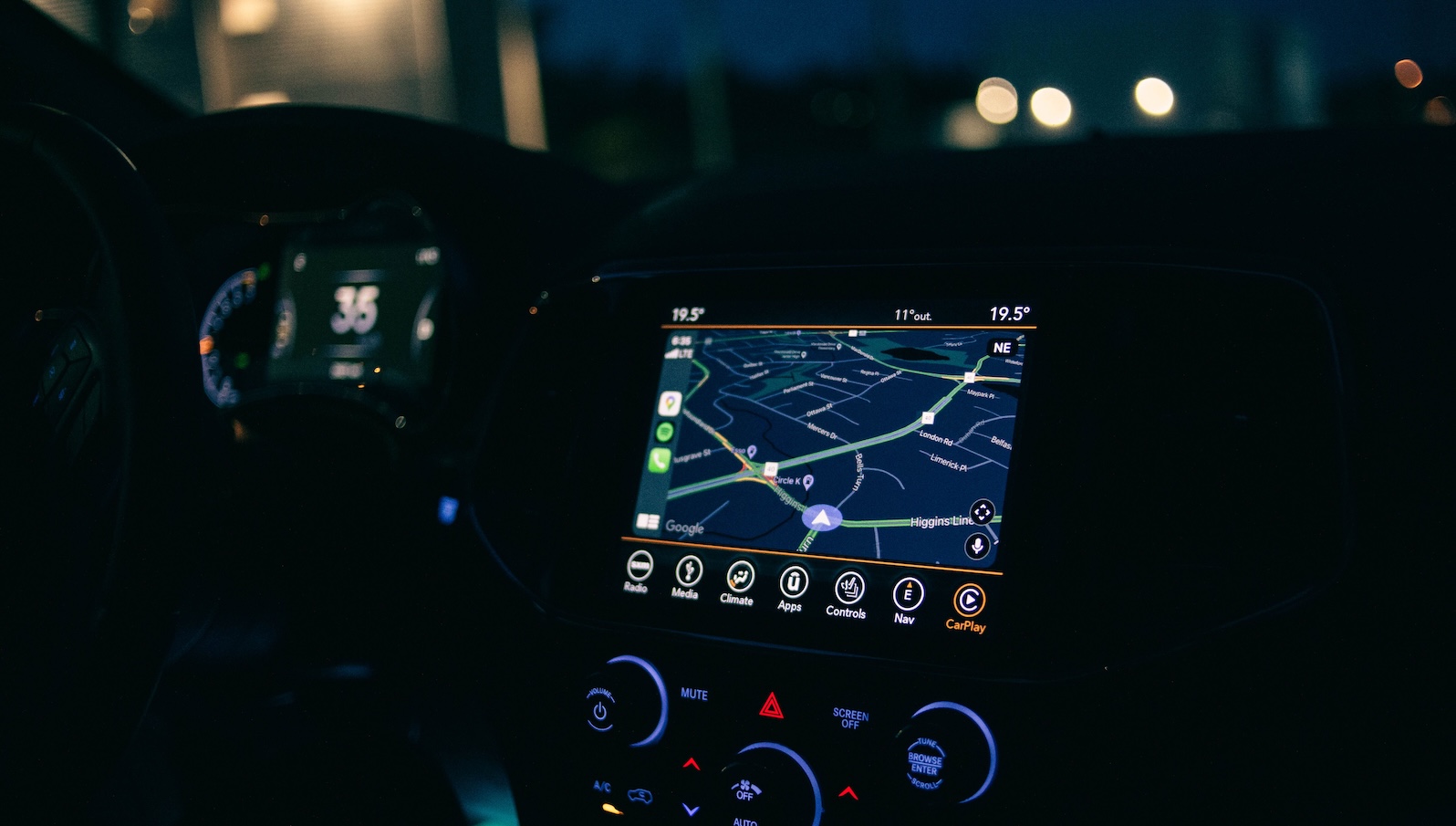 Interior view of a car featuring the GPS navigation system illuminated at night, showcasing technology and modern travel