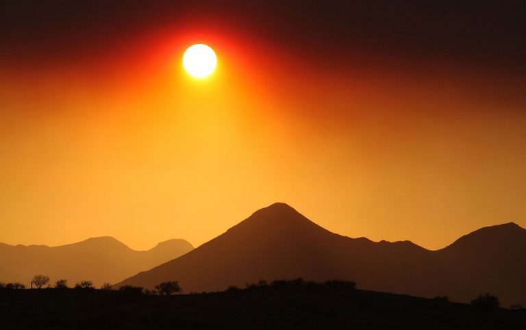 the bright sun over a smoky mountain 