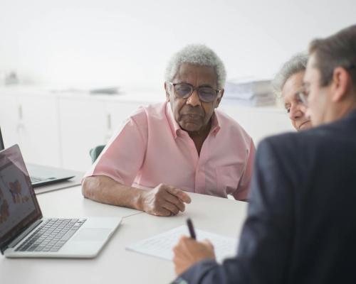 Elderly Couple Discussing Contract with Consultant