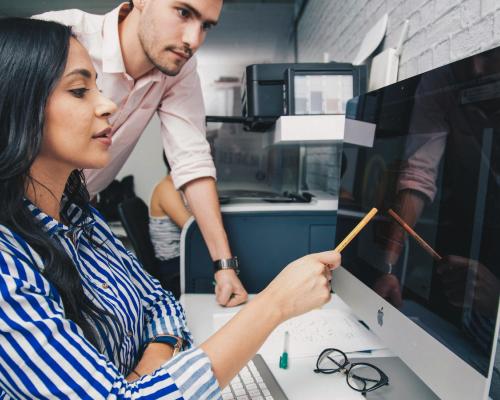 Focused colleagues working on project in office