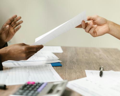 A Person Passing a Document