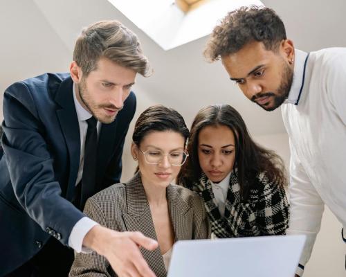 Women and Men Working over Laptop