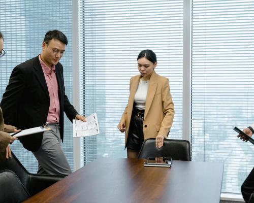 People Sitting Down on Chairs at the Conference Room