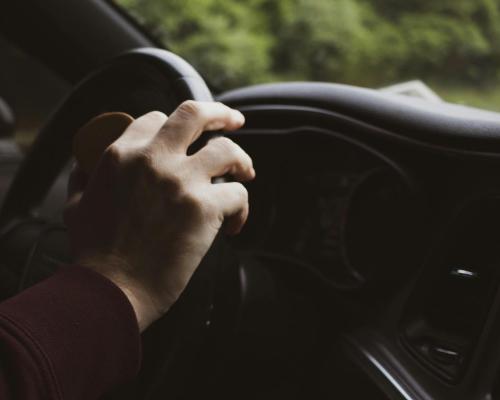 Hand Resting on Steering Wheel
