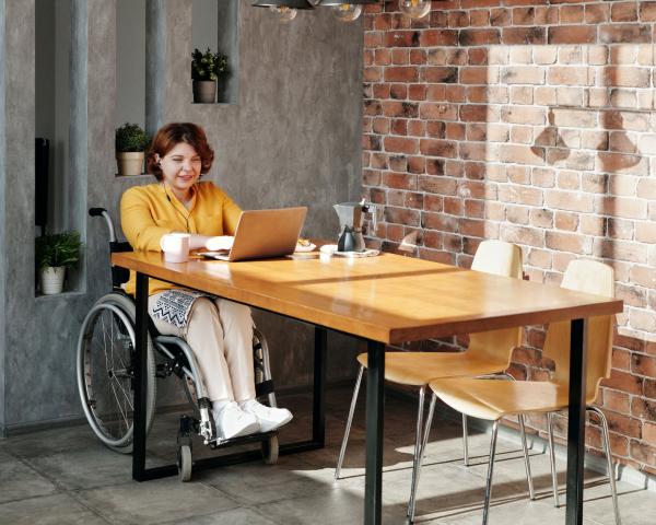 Person in a wheelchair on a laptop