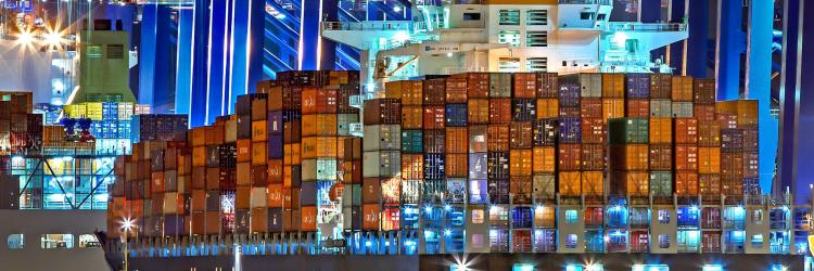 Large cargo ship full of containers at nighttime