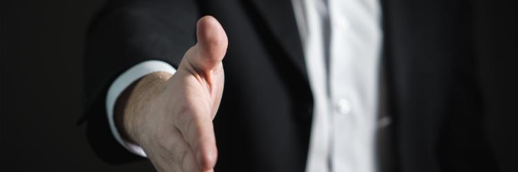 Person holding out hand to shake