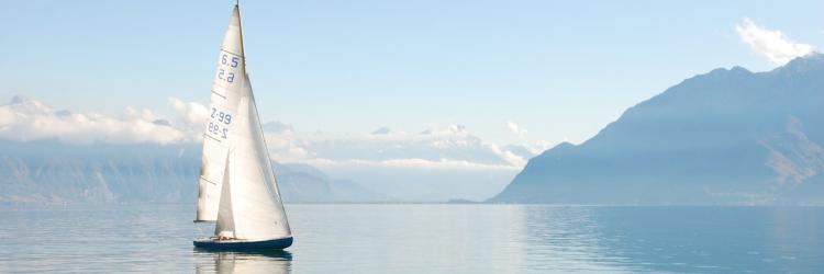 Sailboat on clear blue water in the mountains