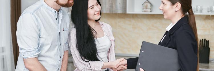 Woman in suit shaking hands with a client