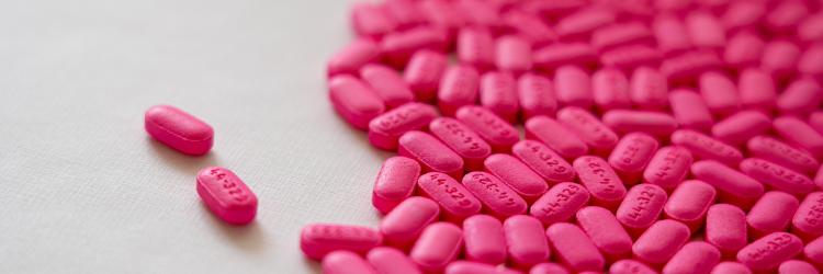 Pink prescription medications on a counter