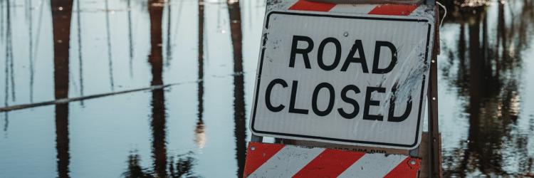 Road closed sign on a flooded road