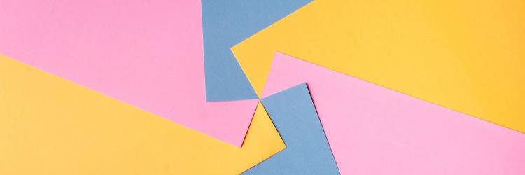 Blue, yellow, and pink pieces of paper swirled