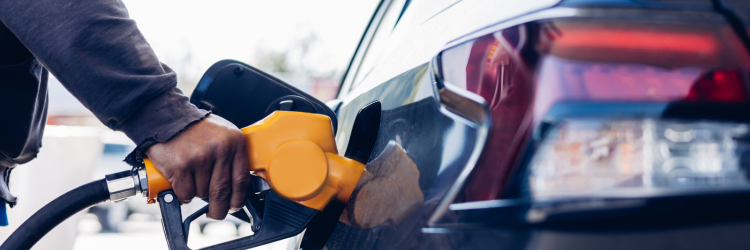 person pumping gas into their car