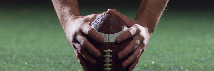 hands snapping a football