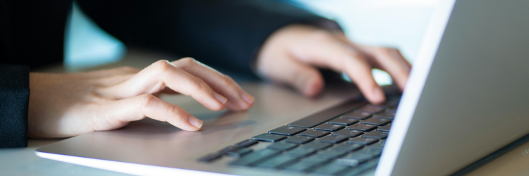 person typing on laptop