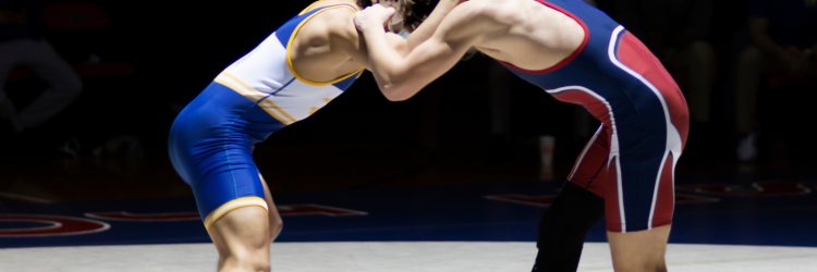 2 Amateur Wrestlers Wrestling in the middle of a wrestling mat