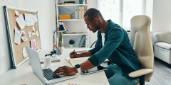 man working from home at desk on computer