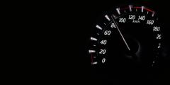 Close Up of Speedometer Against Black Background