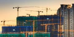 Cranes constructing buildings