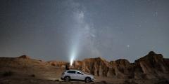 White SUV underneath starry sky